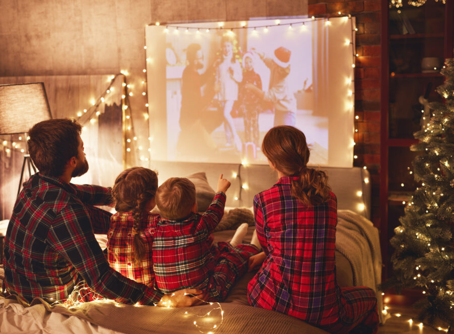 family mother father and children watching projector, film, movi