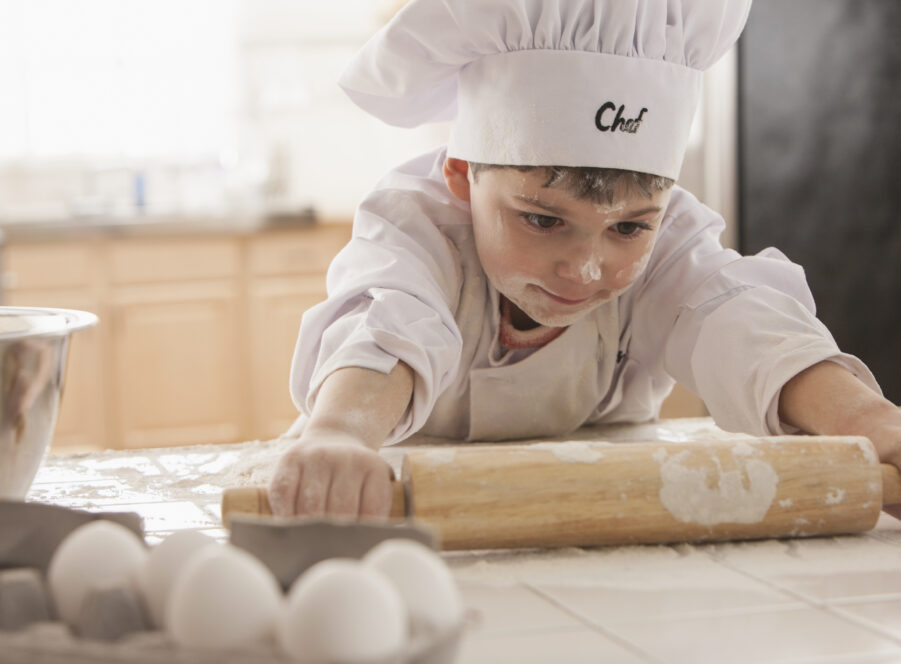 Boy baking in chef's whites