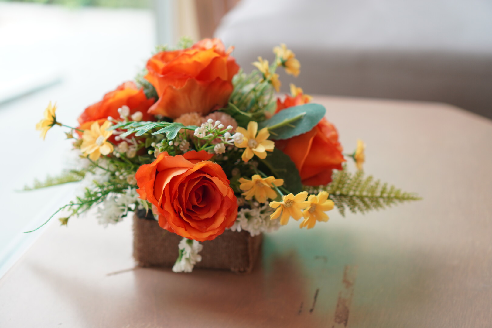 rose artificial flowers in vase on table