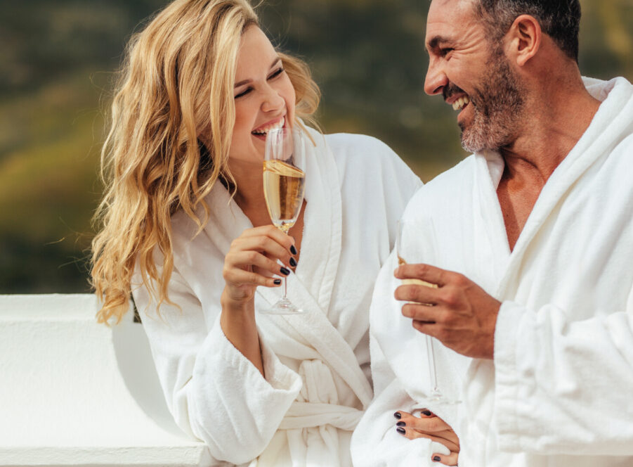 Couple in robes, sipping wine