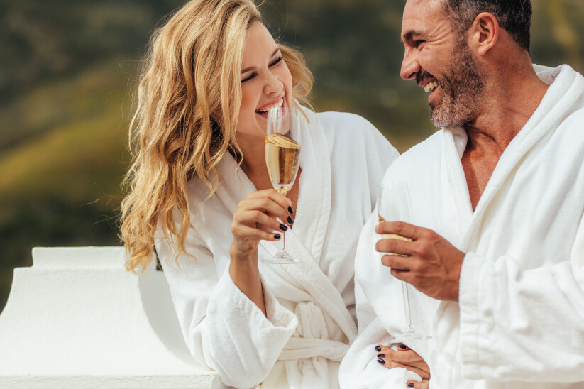 Couple in robes, sipping wine